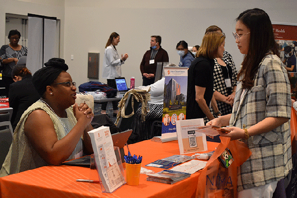 Female student speaking to a rep from a health professions school